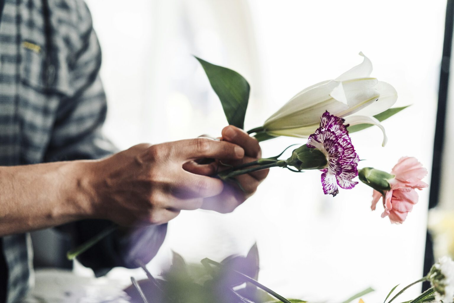 Young male florist working in flower shop